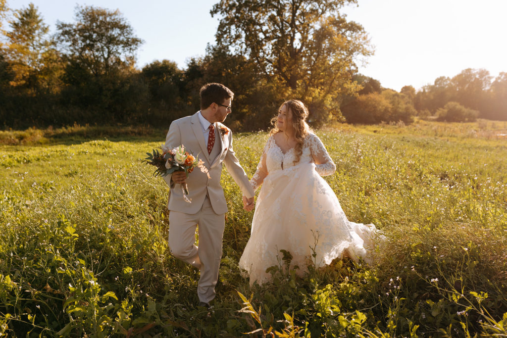 A wedding photo of a couple standing in a meadow during golden hour for the blog unique ways to use your wedding photos