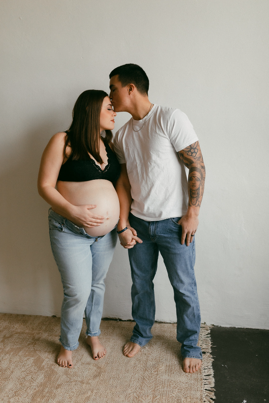 Maternity Session with couple wearing white shirts and denim jeans, mom to be wearing a black bralette