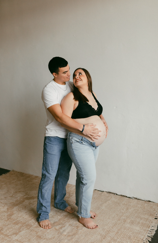 Maternity Session with couple wearing white shirts and denim jeans, mom to be wearing a black bralette