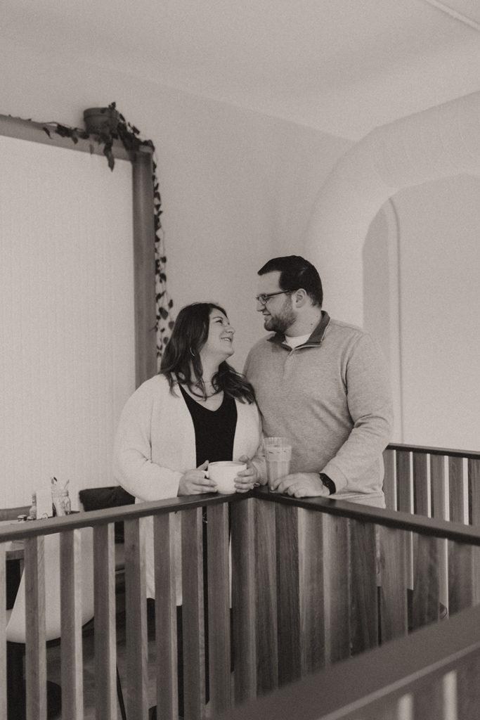 couple standing inside of their favorite coffee shop for engagement photos 