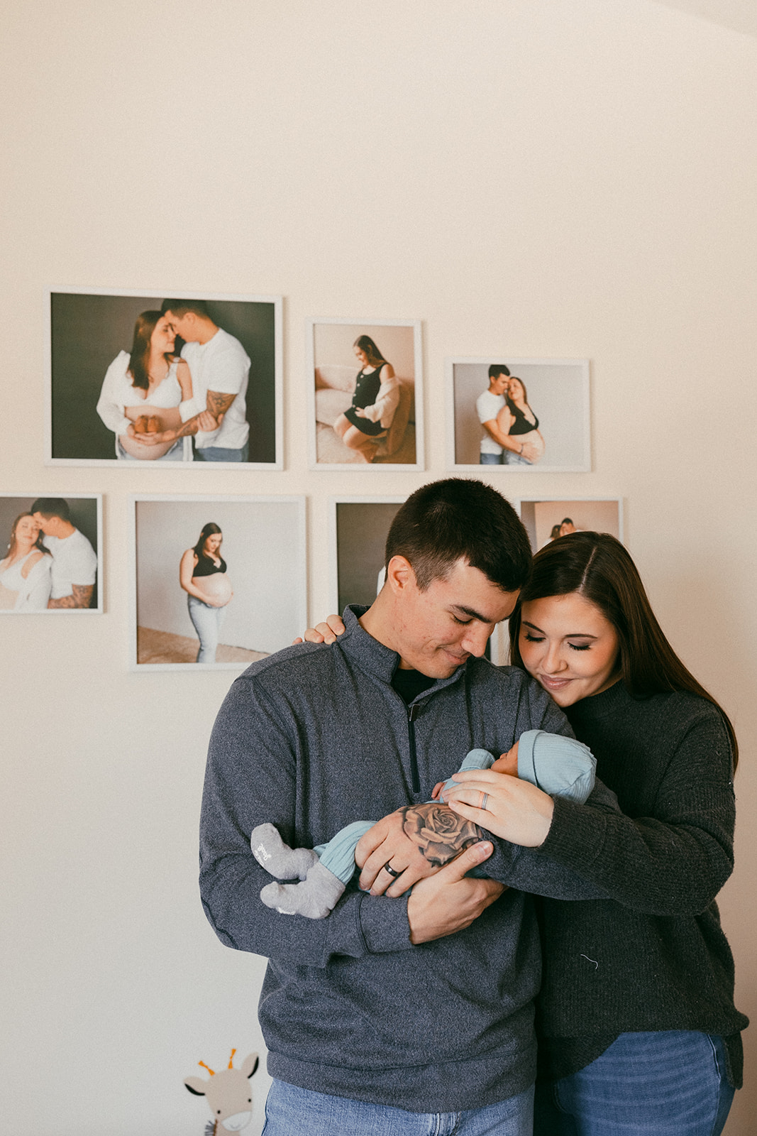 Mom and dad hold their baby boy in his nursery during an in-home newborn session