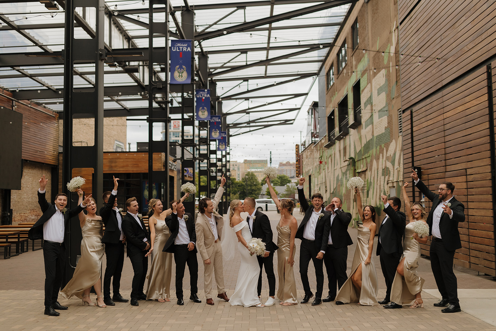 Bride and Groom celebrate with their wedding party during their deer district wedding party portraits in Milwaukee