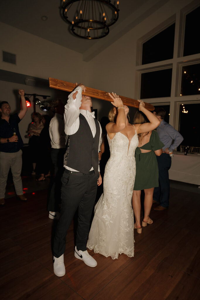 bride and groom use their guest book shotski on the dance floor at the Eloise wedding in Mount Horeb