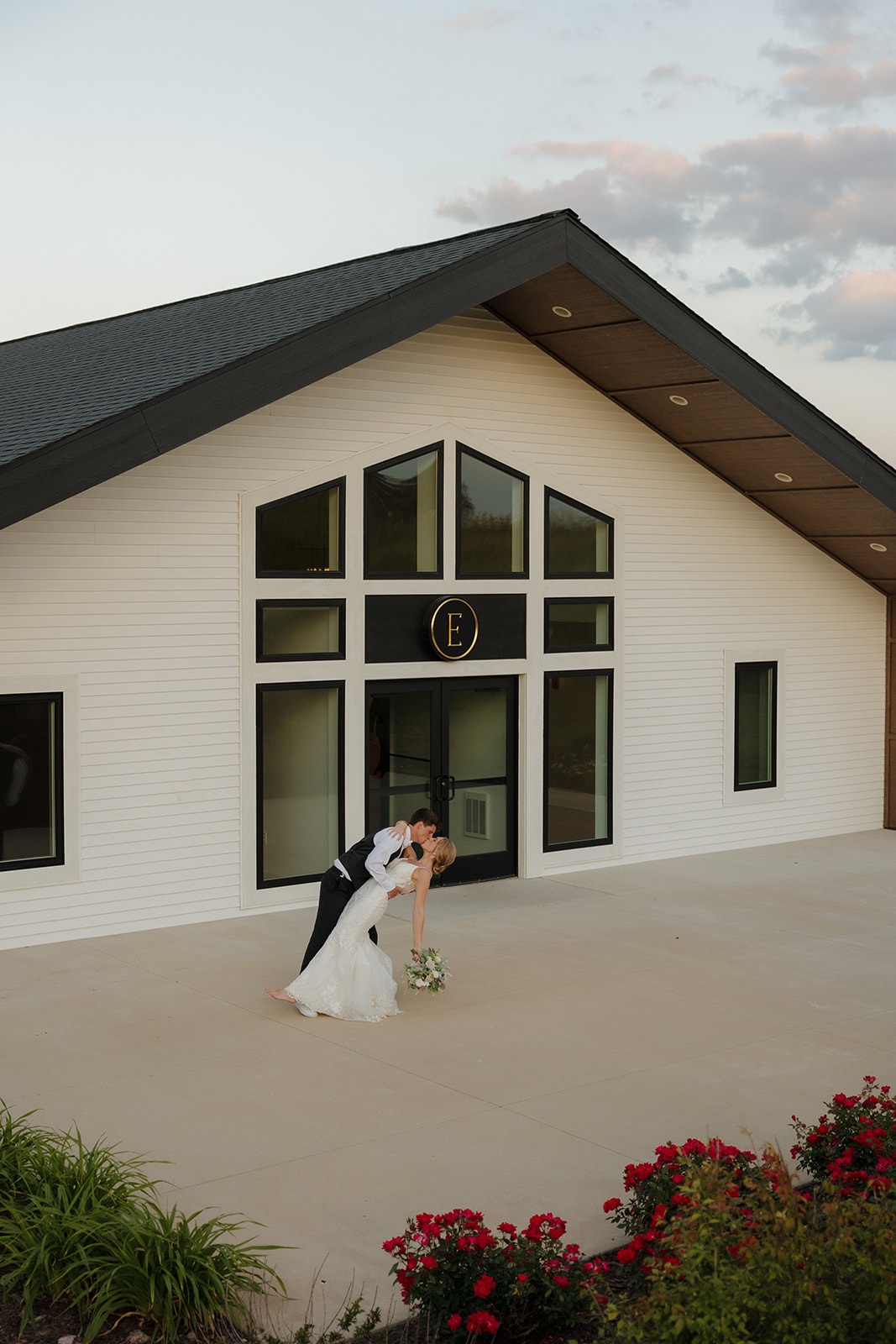 Bride and groom pose together in front of the Eloise wedding venue in Mount Horeb, Wisconsin