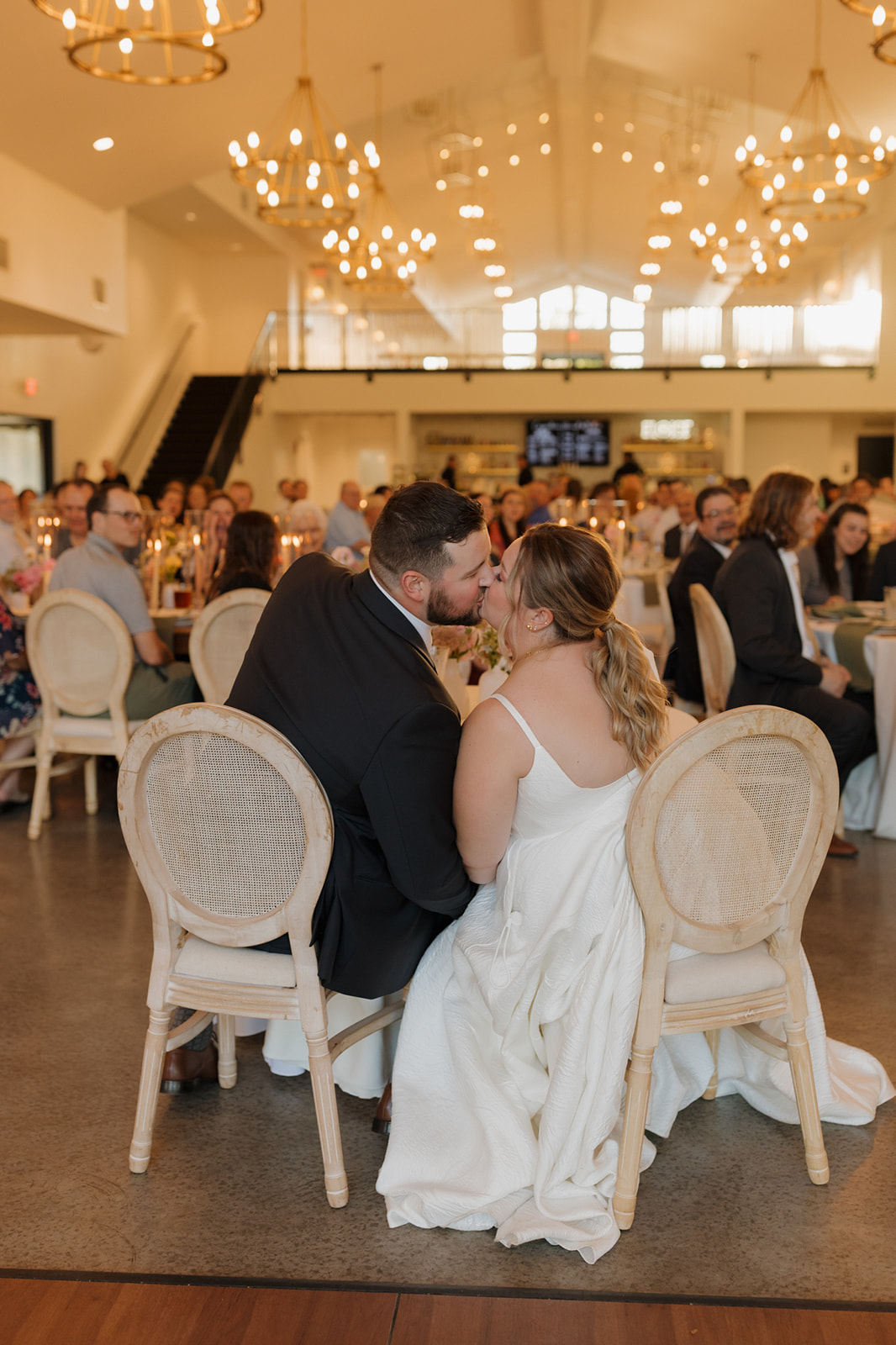 Bride and groom share a kiss during their wedding reception at The Eloise, one of the top wedding venues in Madison