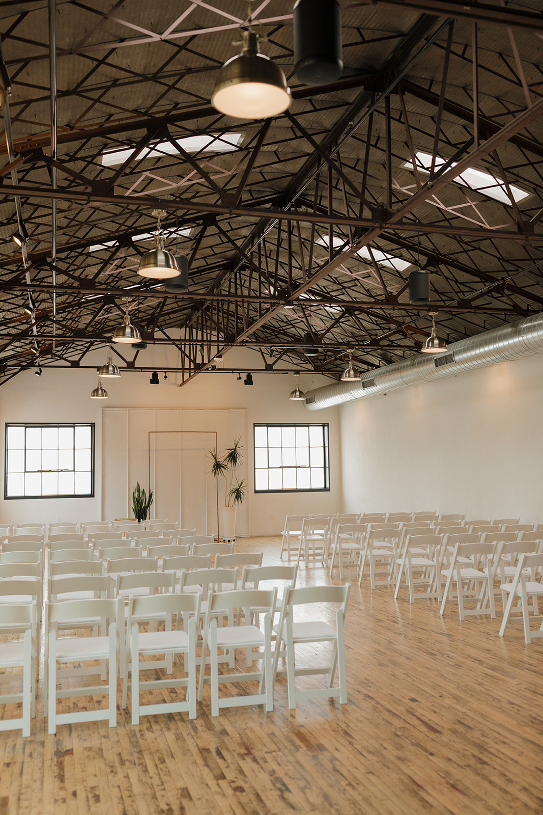 Indoor ceremony setup at The Tinsmith, a modern industrial wedding venue in Madison, Wisconsin