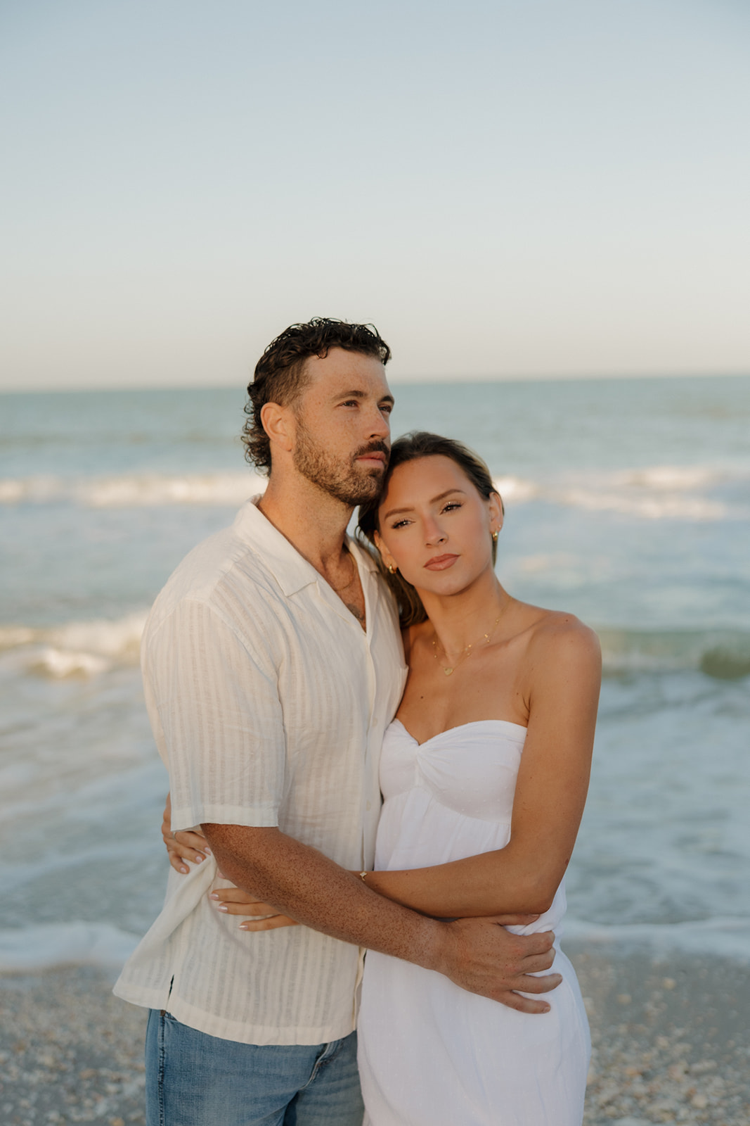 Newly married couple hugging and looking off into the distance after intimate Florida elopement ceremony