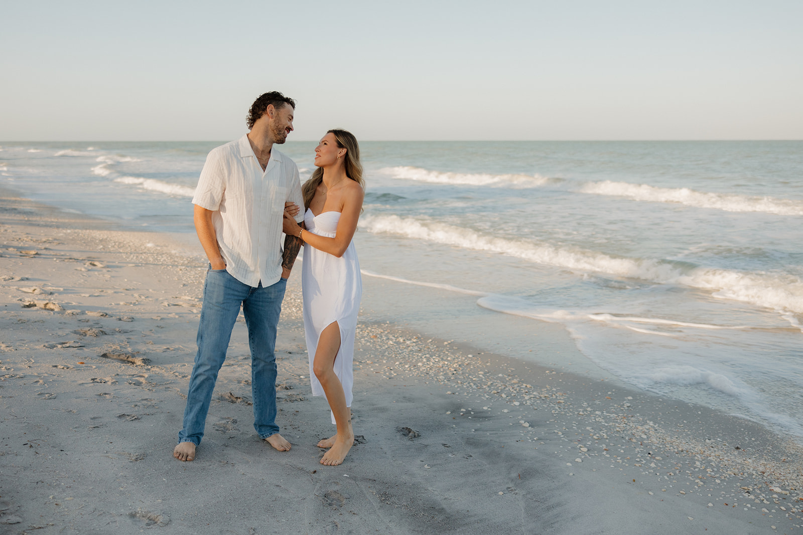 Couple standing on the beach looking at one another after Florida elopement ceremony