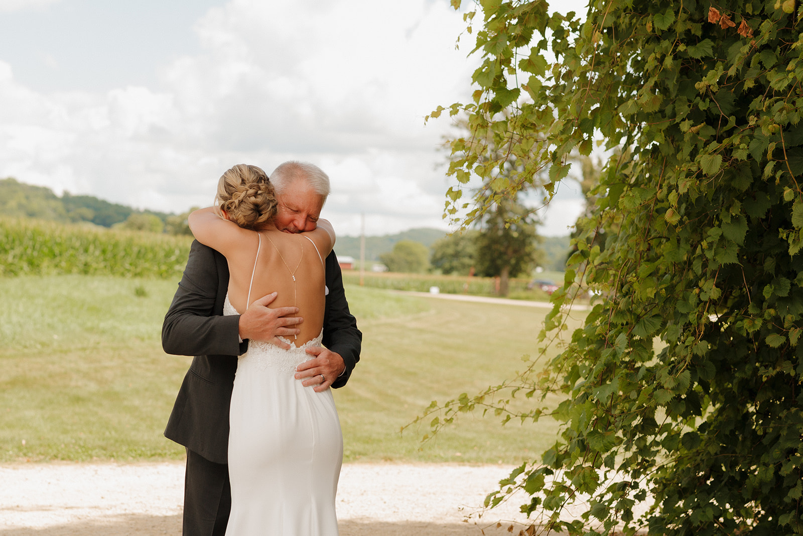 Bride hugs father during first look before wedding day as father gets emotional seeing his daughter for the first time on her wedding day