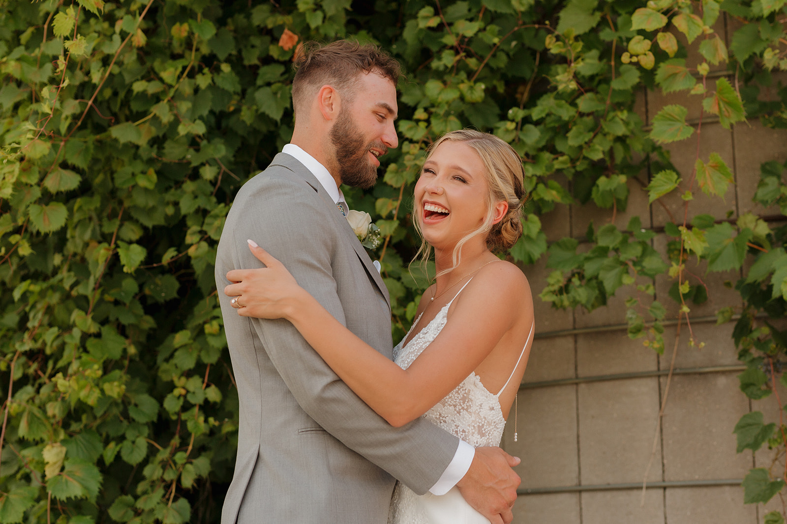 Couple laughing together while embracing after intimate wedding ceremony