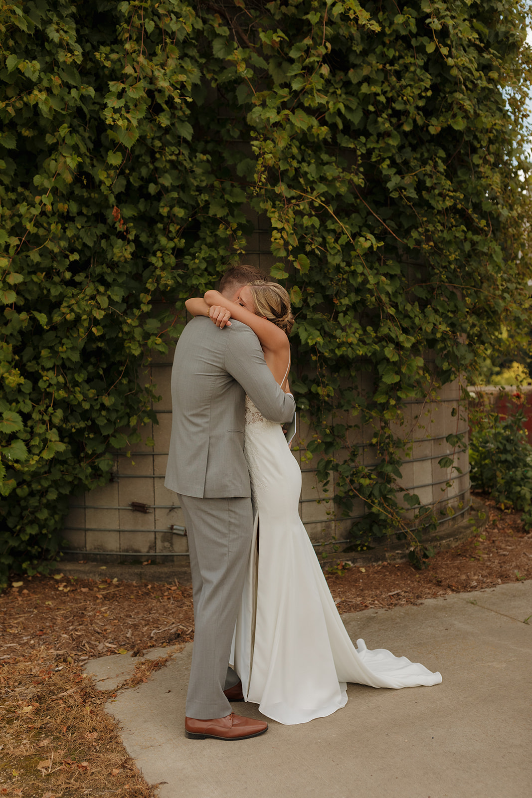 Bride getting emotional during private vow reading and hugging her groom tight 