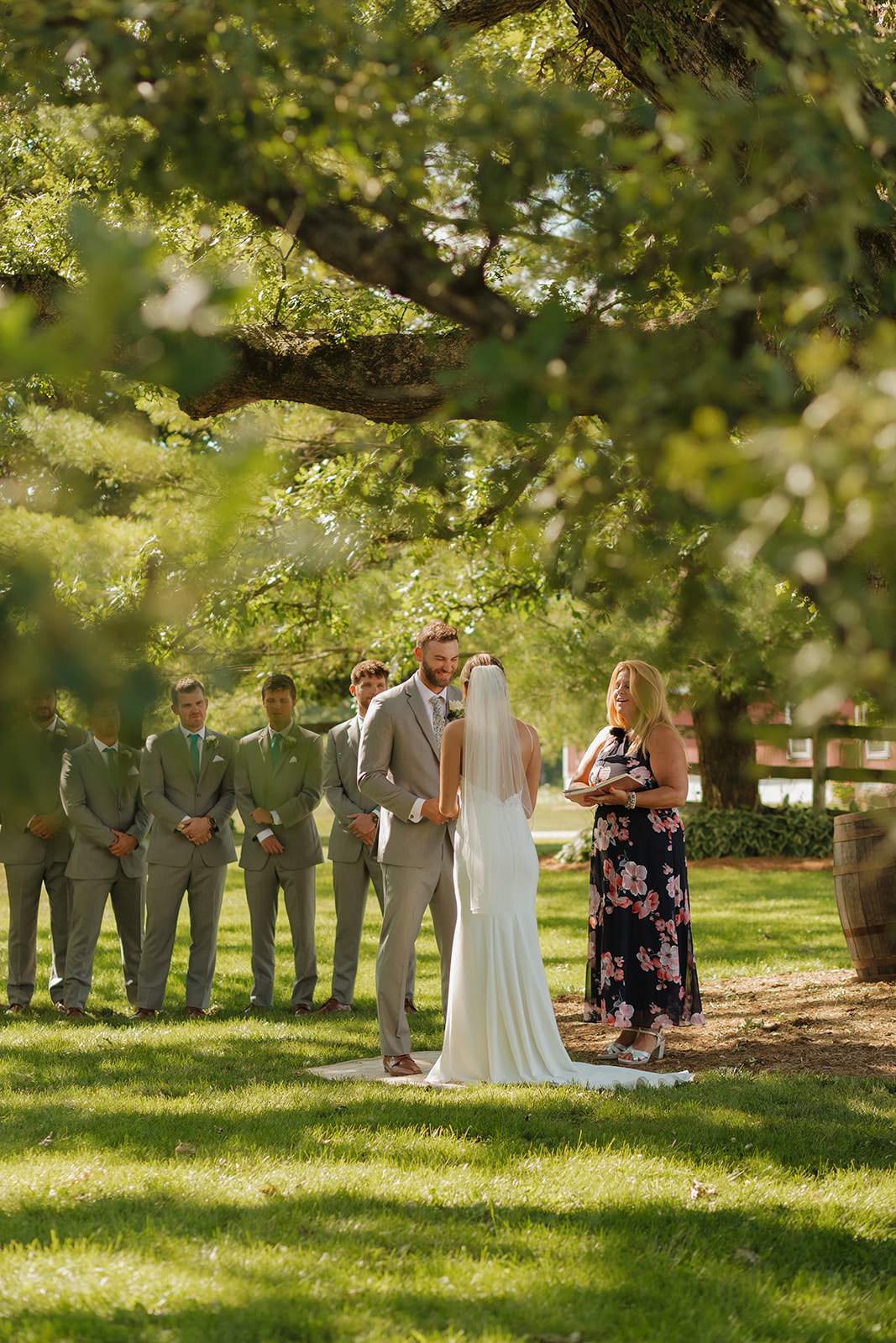 Bride and groom holding hands during intimate wedding ceremony 