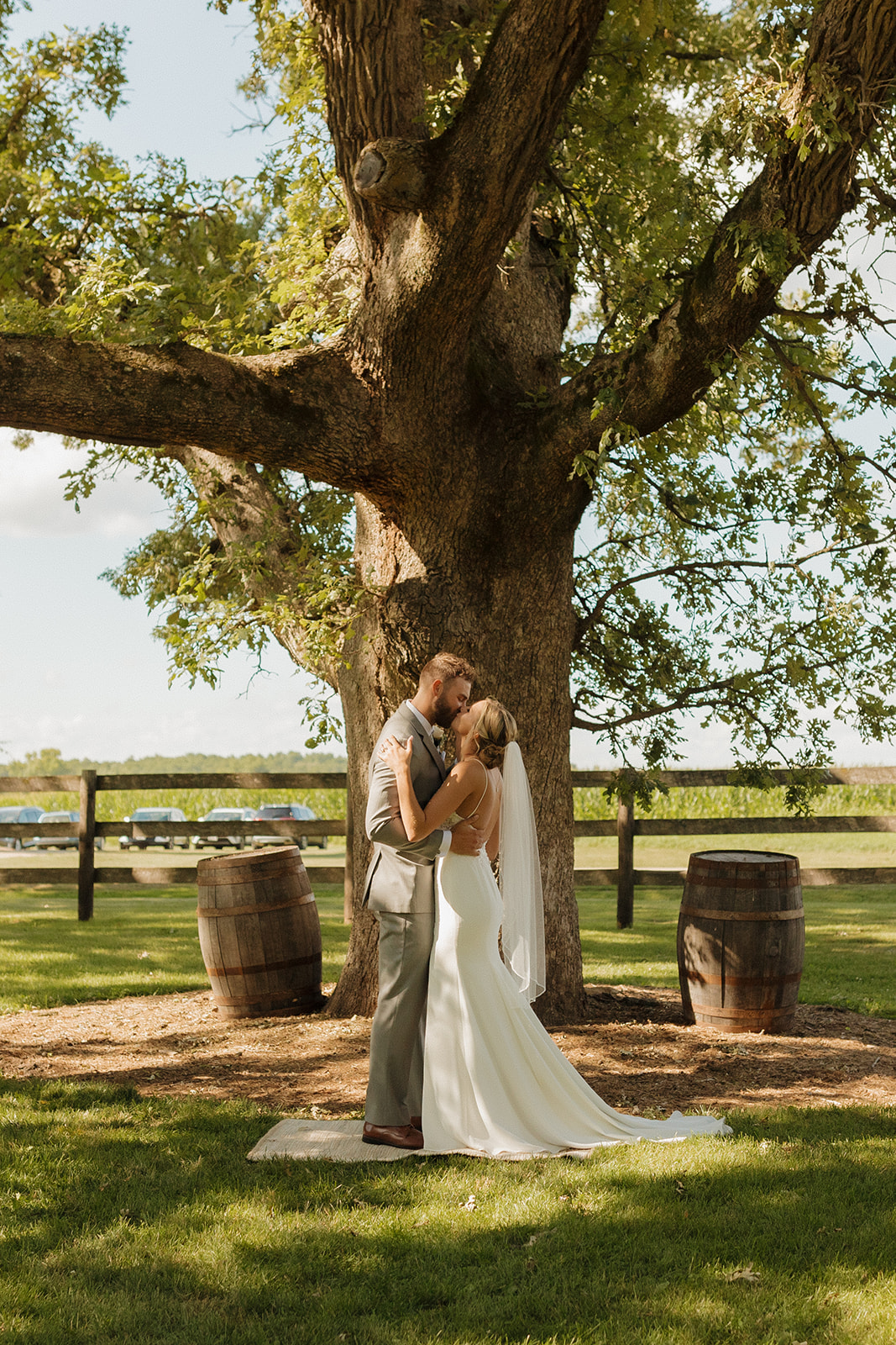 Bride and groom kiss as newly married couple after planning numerous outdoor wedding ideas for their big day