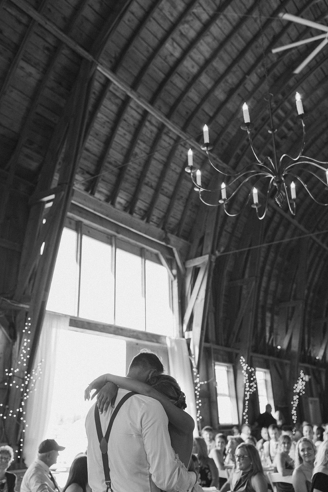 Bride and groom embracing during romantic first dance during evening reception
