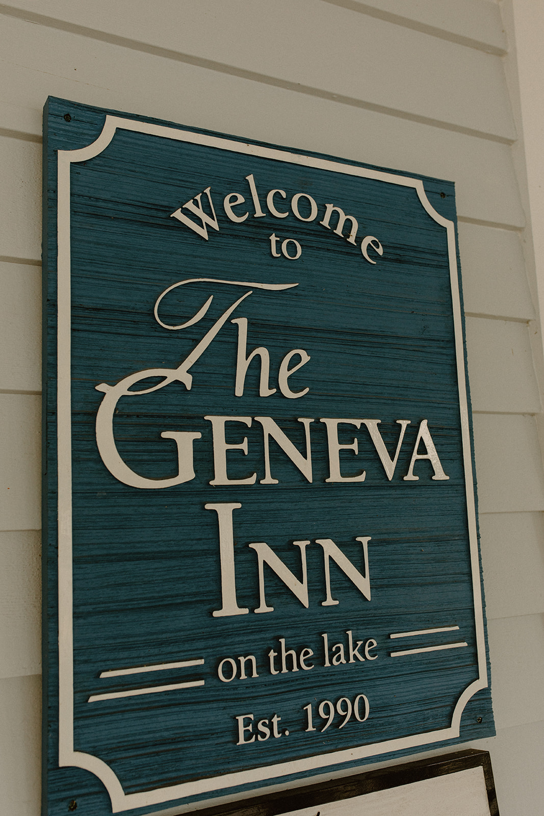 Wood sign of 'the Geneva Inn' captured before Lake Geneva wedding