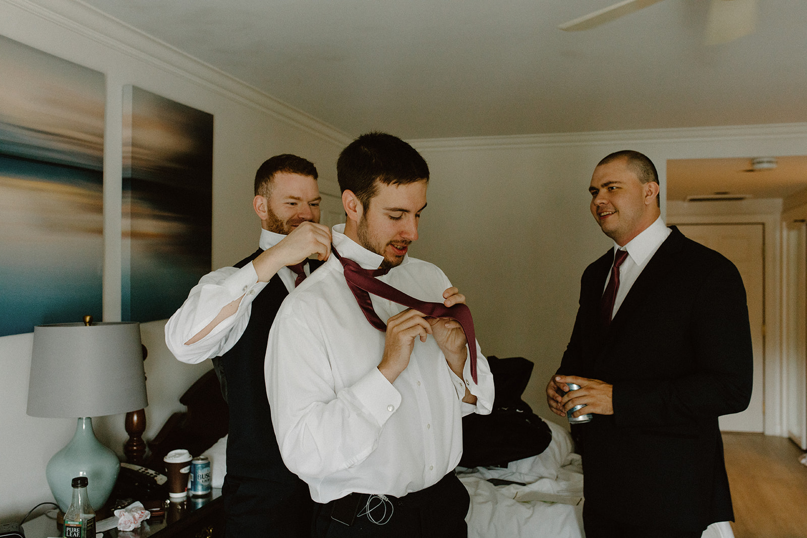 Groom getting ready with his groomsmen in a relaxed Lake Geneva wedding suite