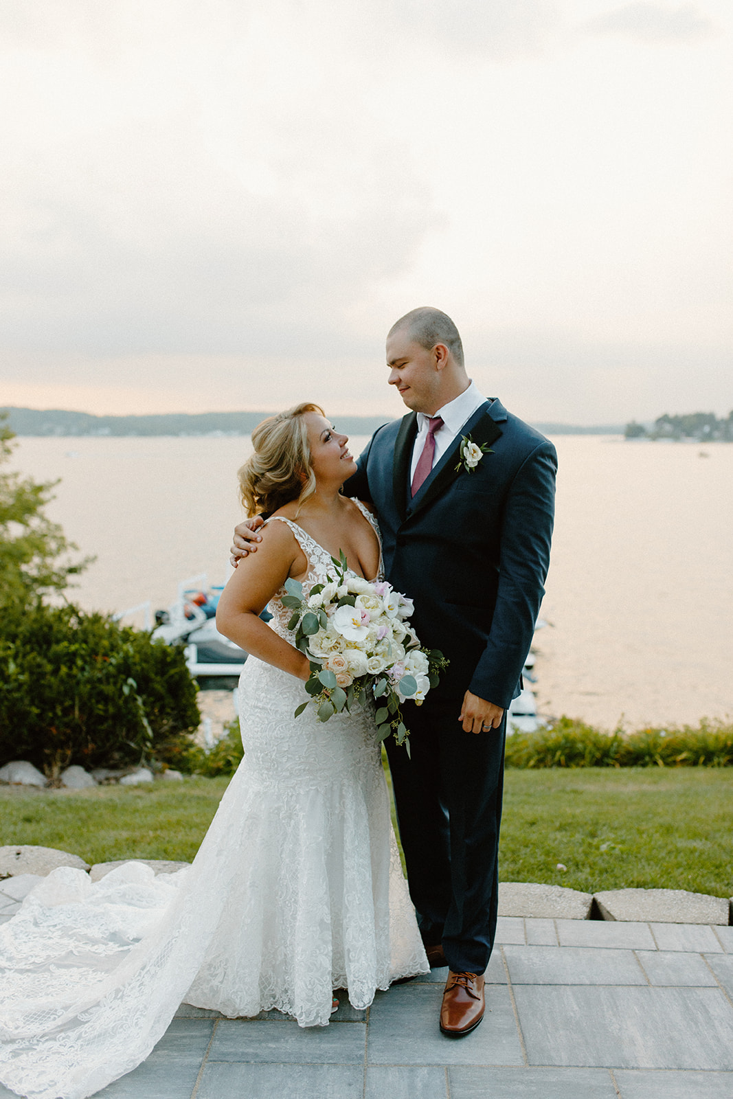Bride and groom gazing at each other during golden hour by the water after their Lake Geneva wedding ceremony