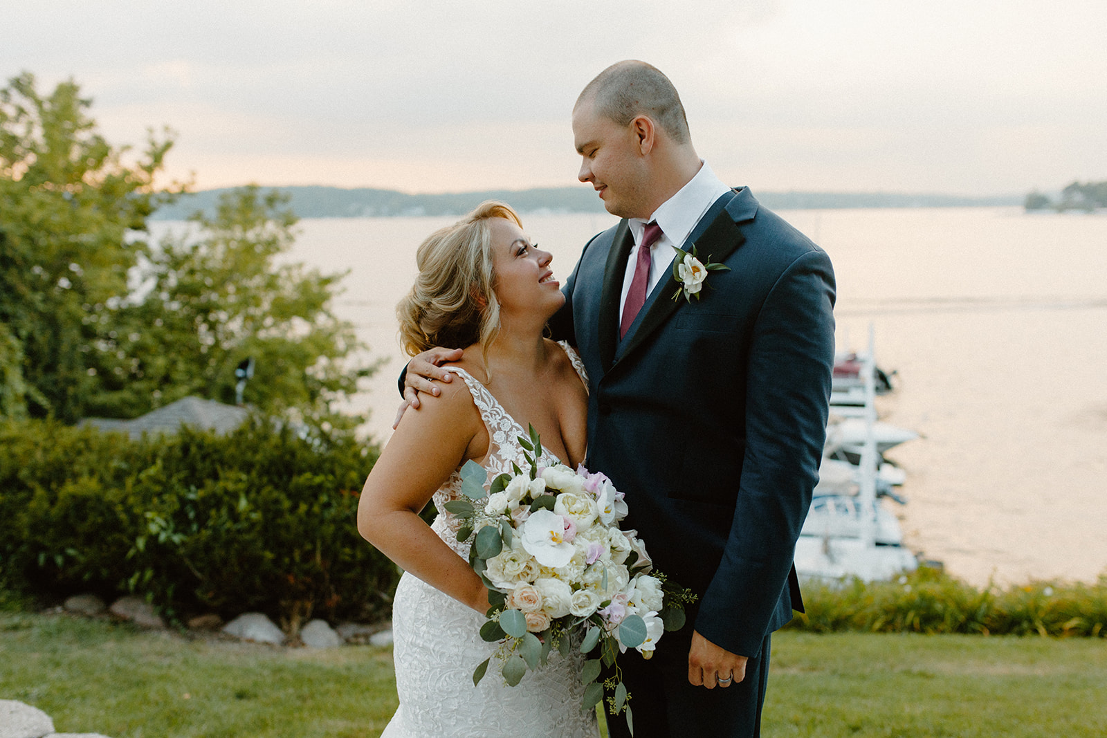 Bride and groom sharing a quiet moment at golden hour, with a romantic lakeside backdrop during their Wisconsin wedding celebration.