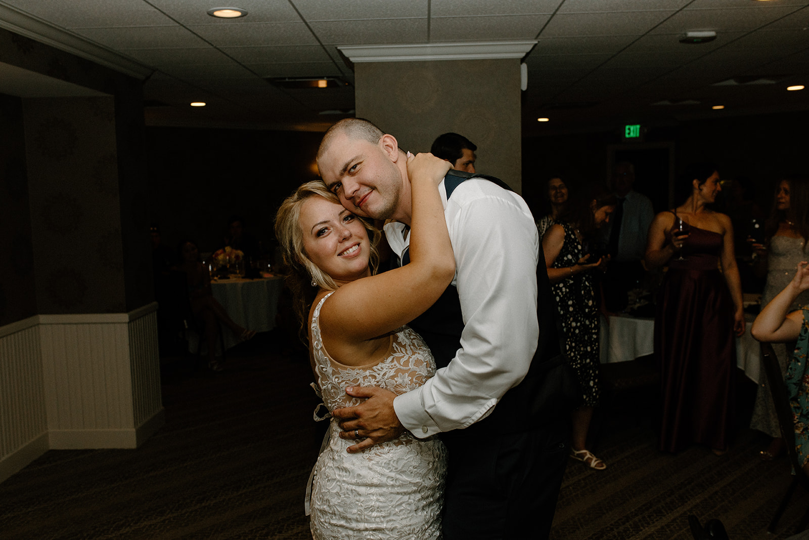 Bride and groom share a slow dance surrounded by guests during their Lake Geneva wedding reception