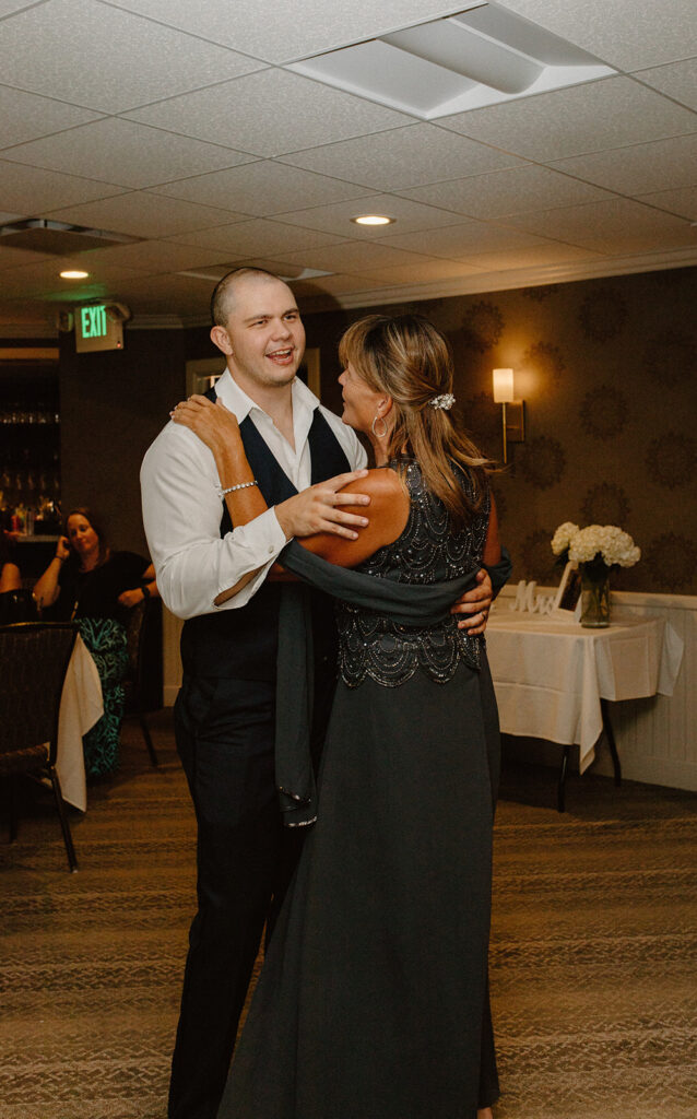 Groom dancing with his mother in an emotional moment at the reception

