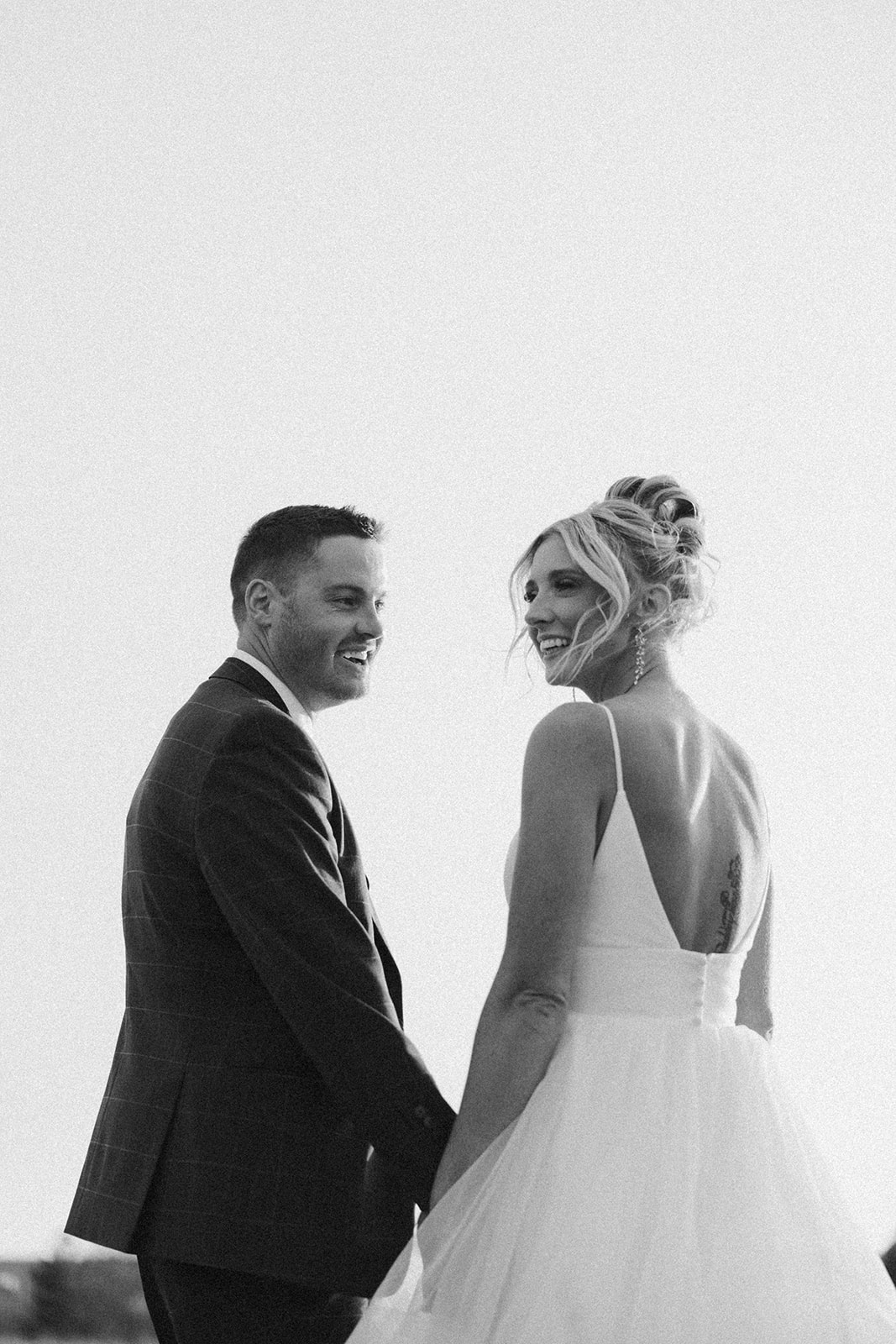Timeless black and white portrait of a bride and groom holding hands at their Madison Wisconsin