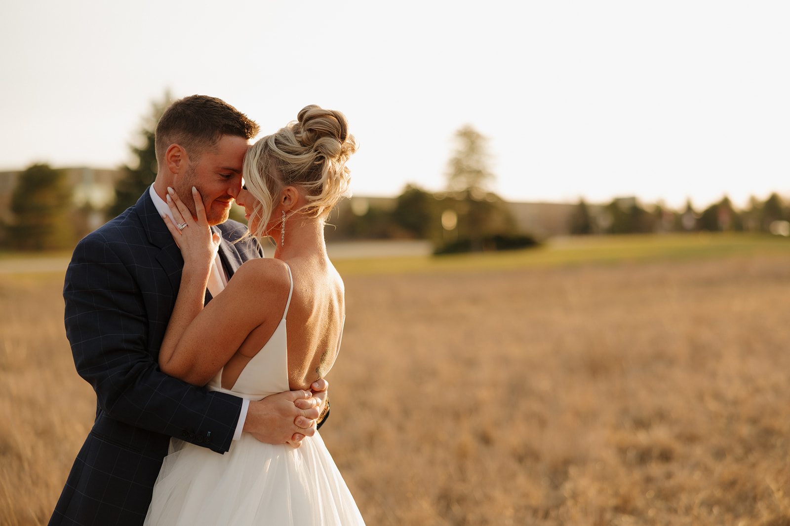 Soft, romantic moment between bride and groom at sunset during their Madison Wisconsin wedding.