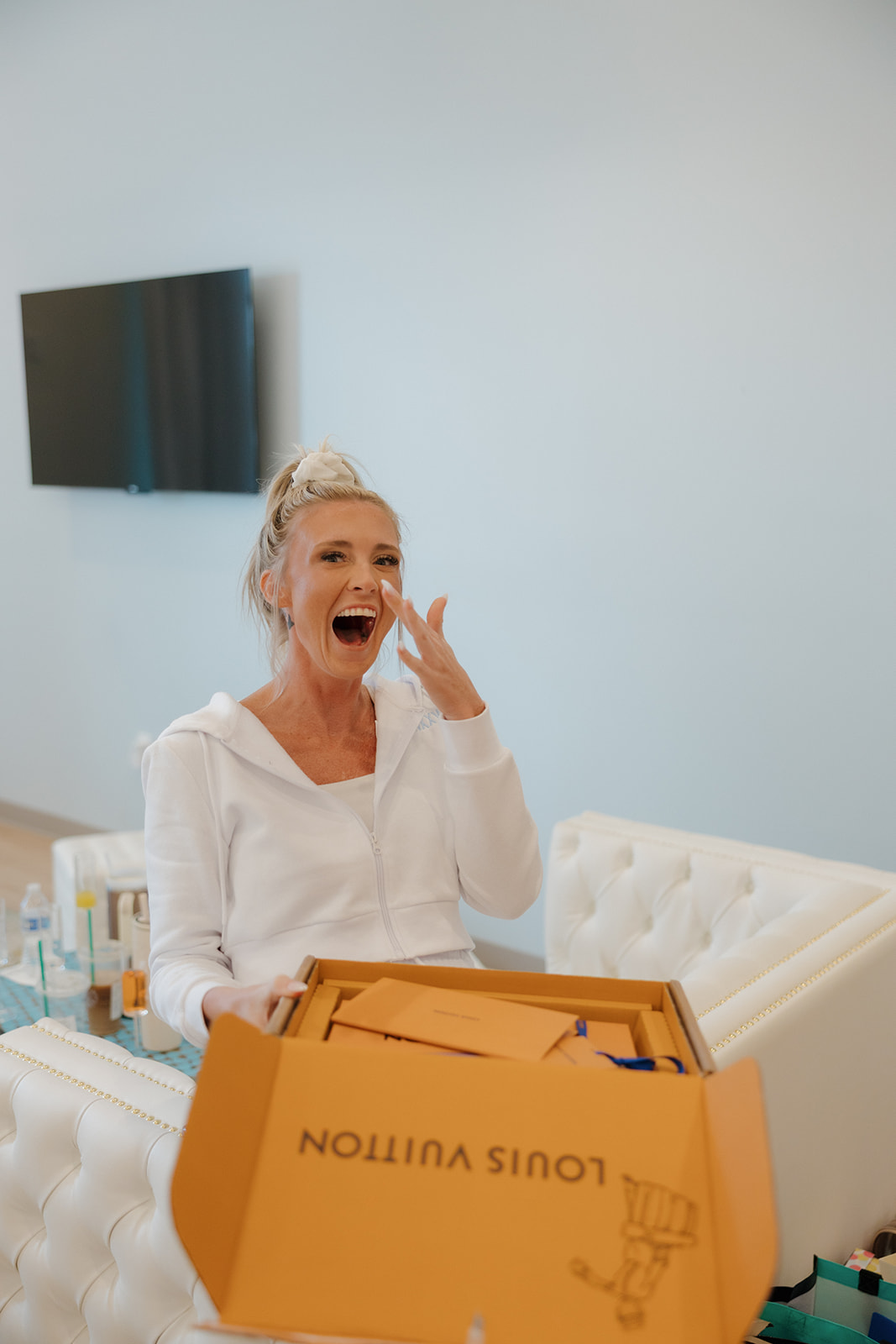 Bride wipes away a happy tear after opening her wedding morning gift—pure Madison Wisconsin wedding magic.