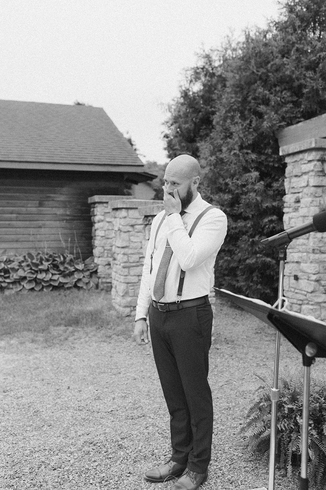 Groom fights back tears as he sees his bride for the first time during a heartfelt moment at their outdoor wedding ceremony.