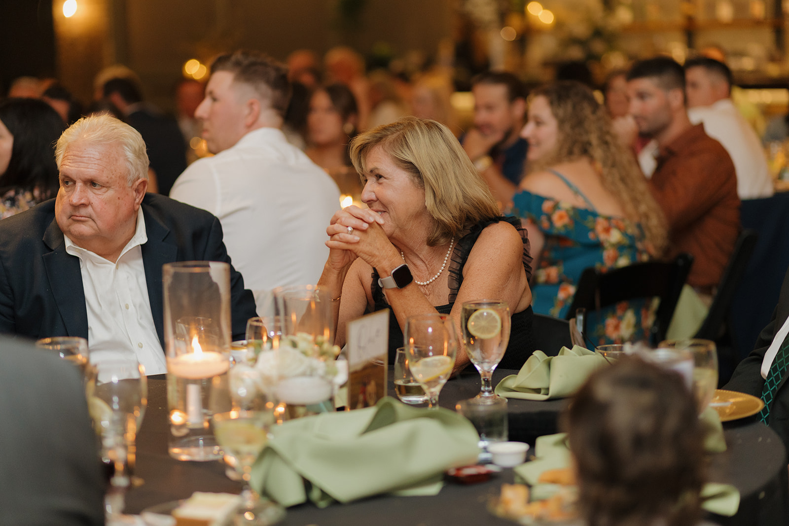 Wedding guests sitting at reception tables celebrating bride and groom during Milwaukee wedding 