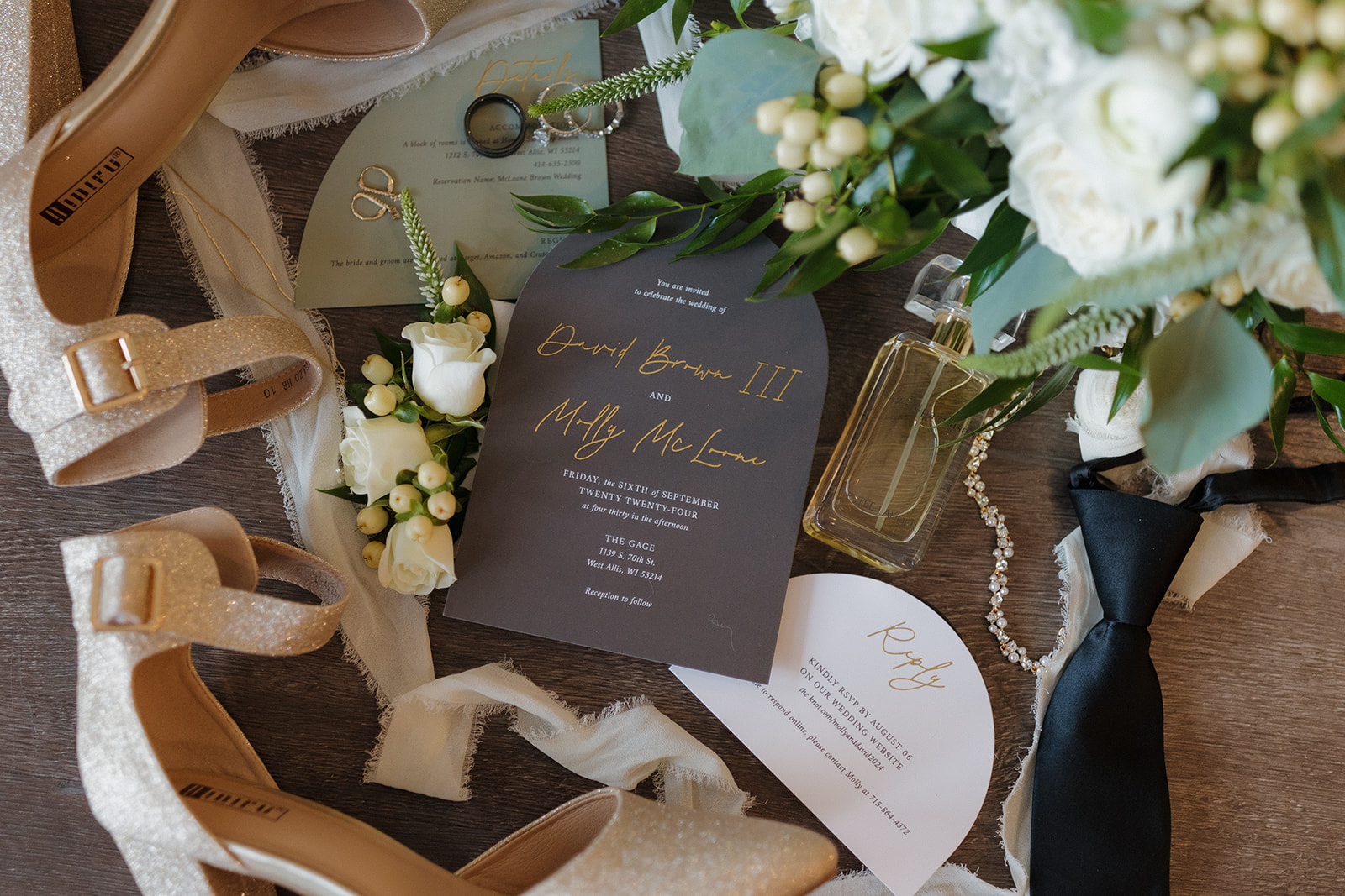 Elegant flatlay of wedding invitations, florals, shoes, and bridal accessories at a modern Milwaukee wedding.