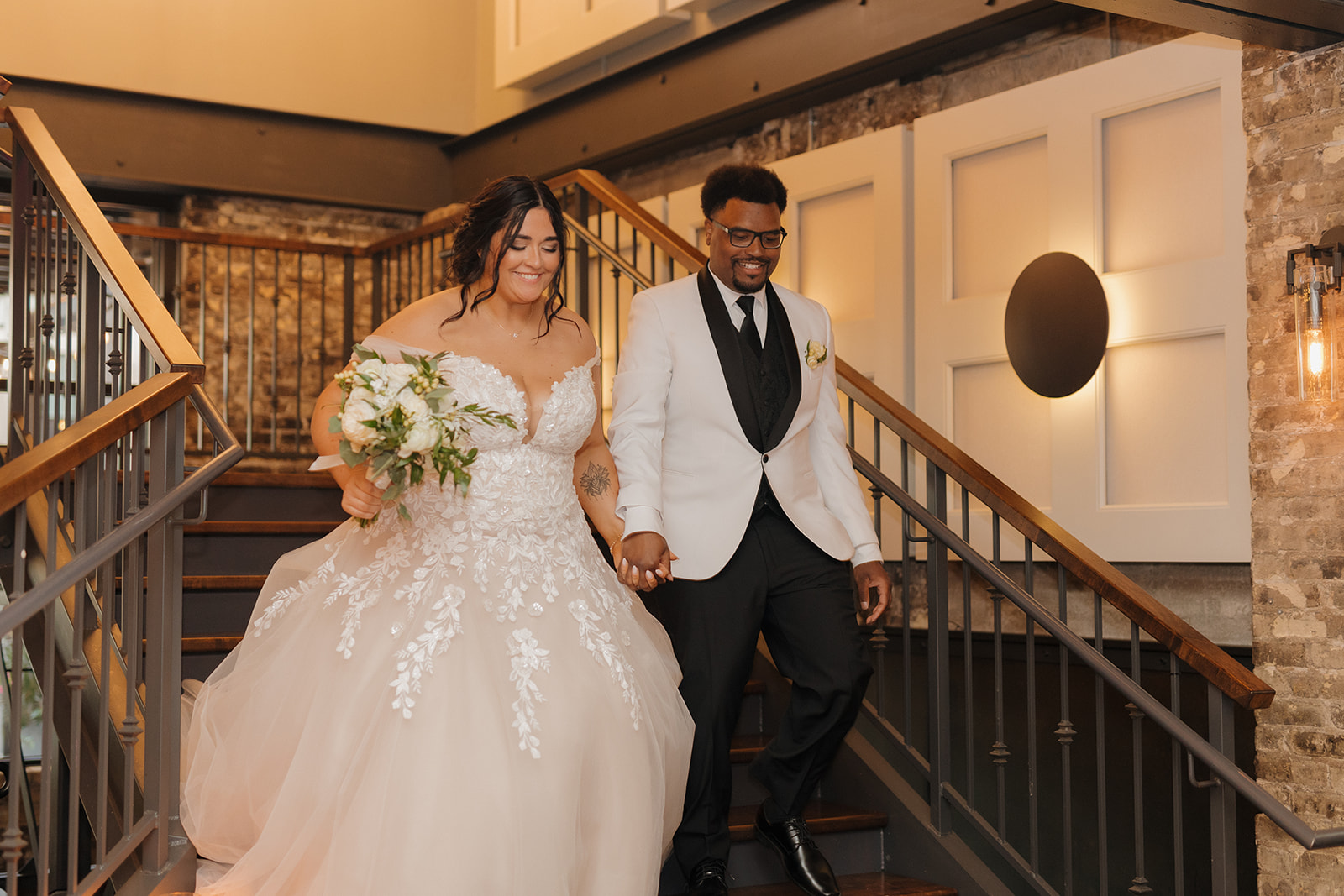 Bride and groom holding hands and walking into reception area to celebrate marriage