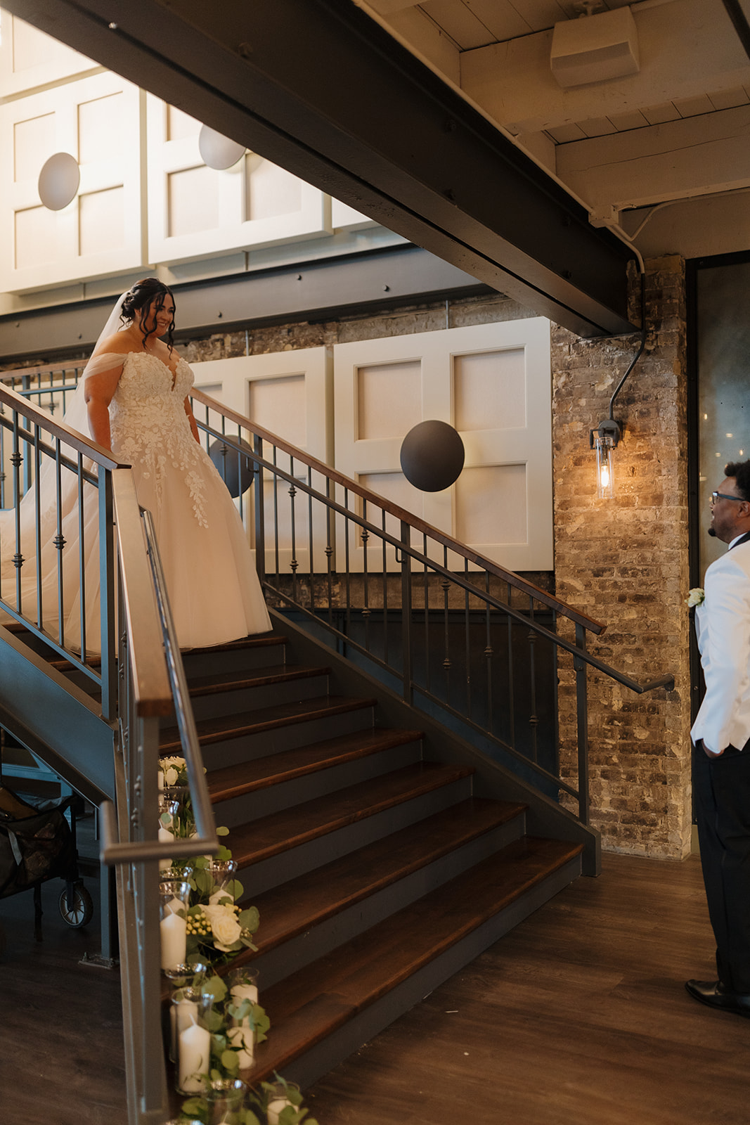 Bride descends staircase in her wedding gown for the first look at The Gage.