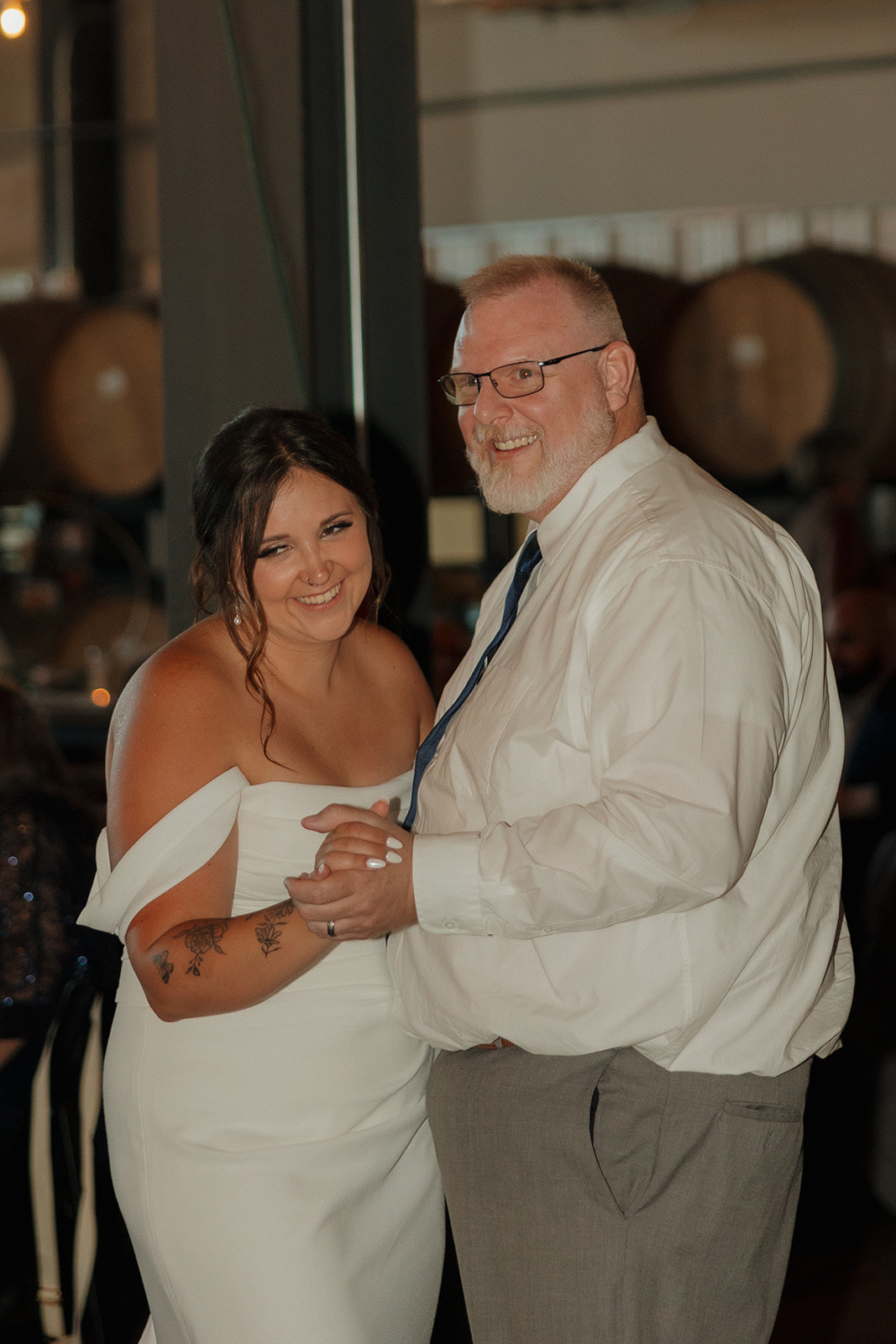 Bride and her father share a joyful dance during the reception at a Wisconsin brewery wedding celebration.
