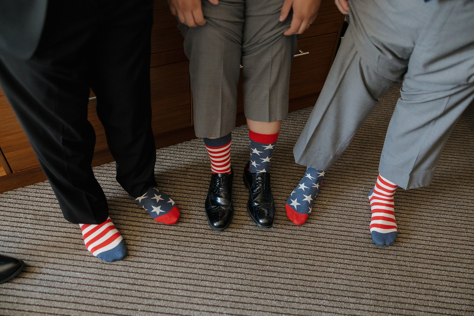 Groomsmen rock red, white, and blue American flag socks—a playful wedding day detail at a Wisconsin brewery.