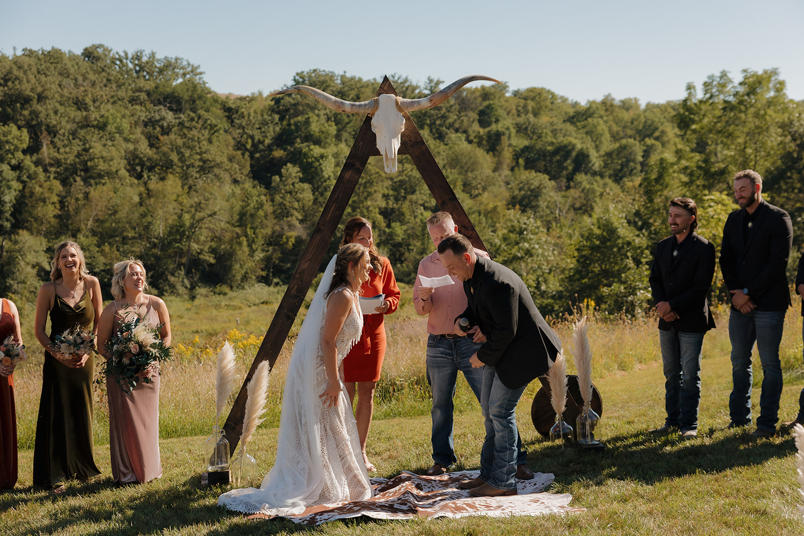 Bride and groom laughing together during intimate vow ceremony 