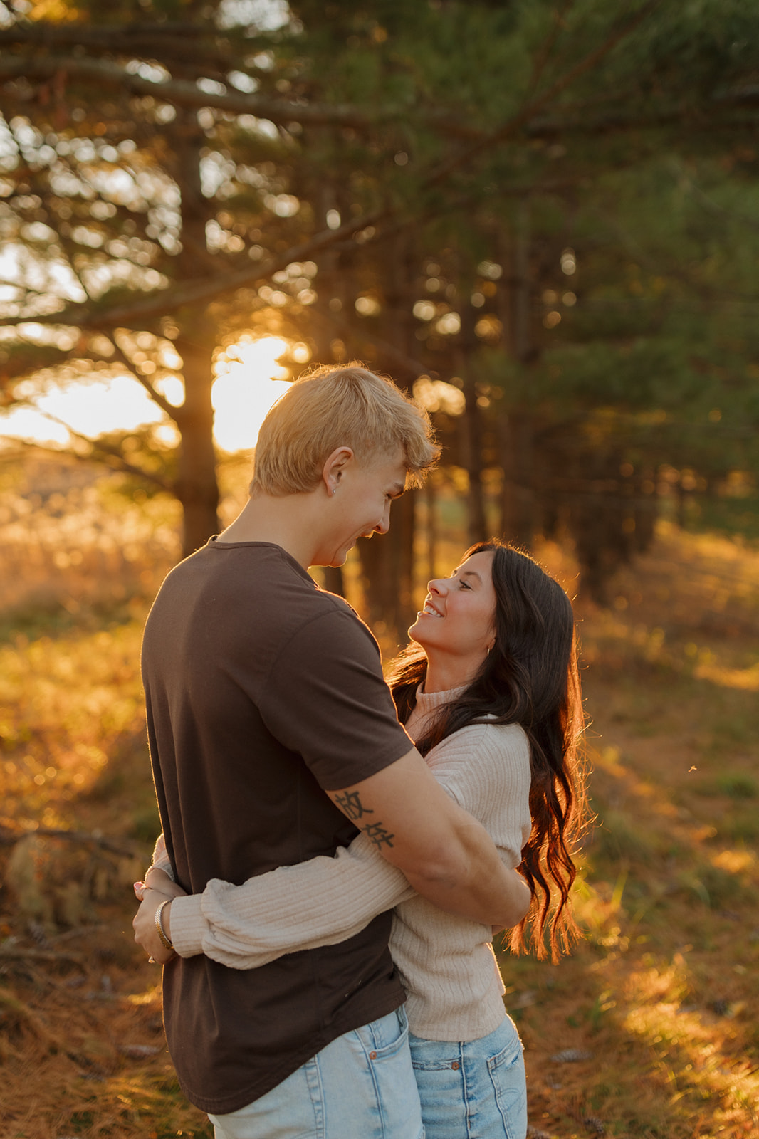 A couple poses in a serene wooded area for engagement photos, taken by a Madison WI wedding photographer.
