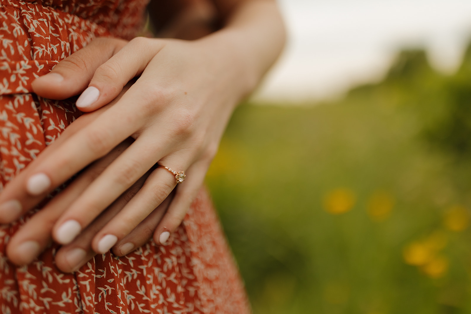 A woman's hands gently hold a sparkling wedding ring, showcasing its elegant design and significance.