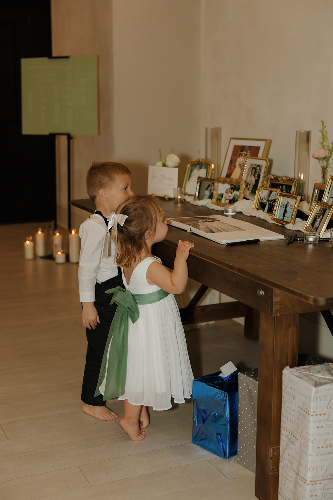 Beautiful welcome table set up with flower girl and ring bearer looking on. A simple yet powerful memorial to those who have passed on. 