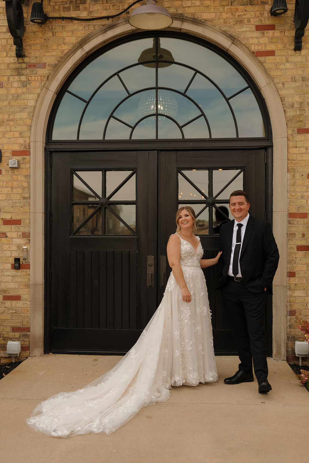 Couple smiles together after seeing one another for first time on wedding day 