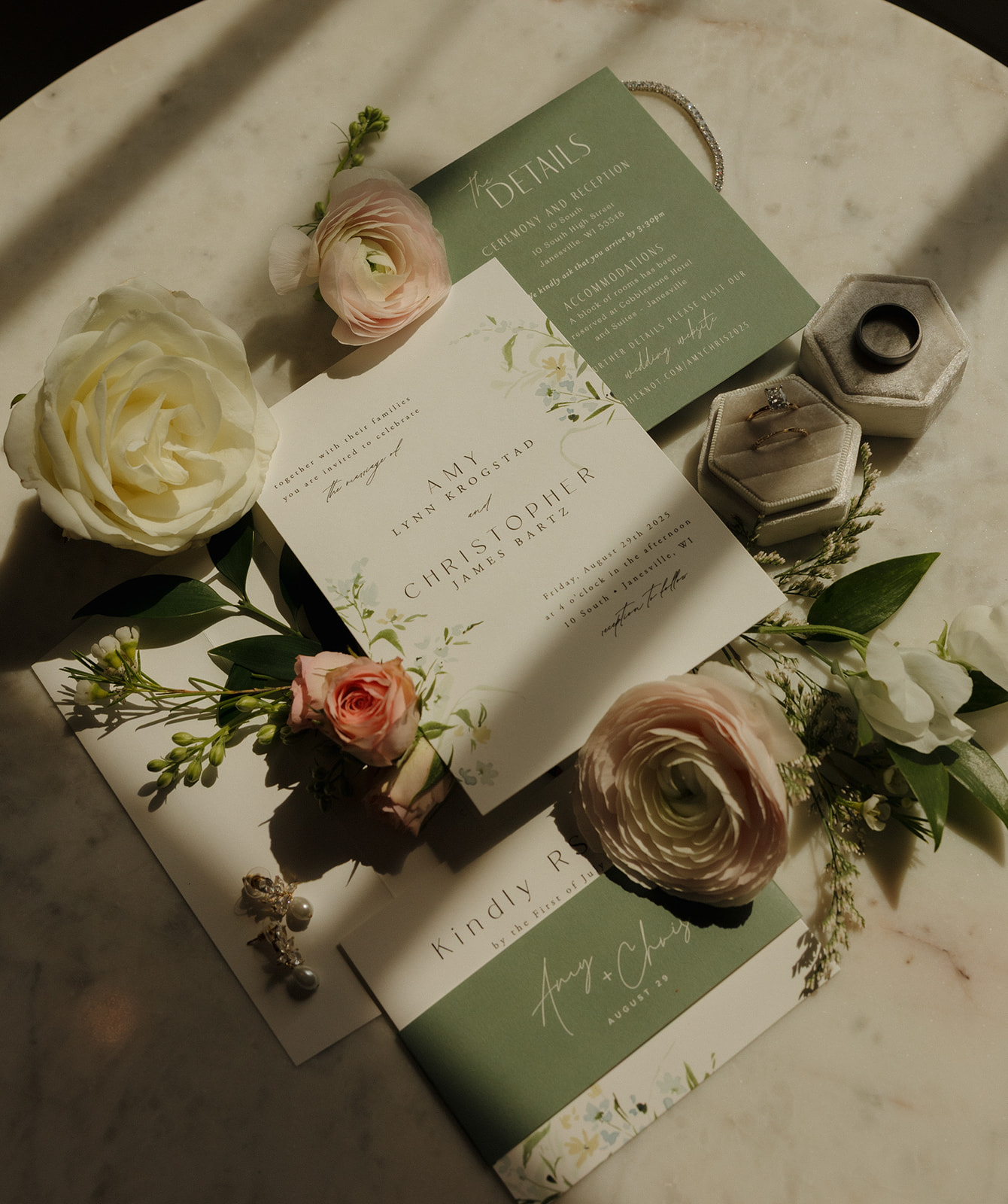 A beautifully designed wedding invitation with flowers on a marble table, highlighting the charm of the 10 South wedding venue.