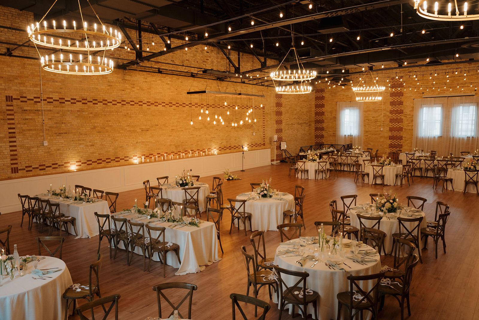 A spacious wedding reception room filled with elegantly set tables and chairs, ready for guests to celebrate.