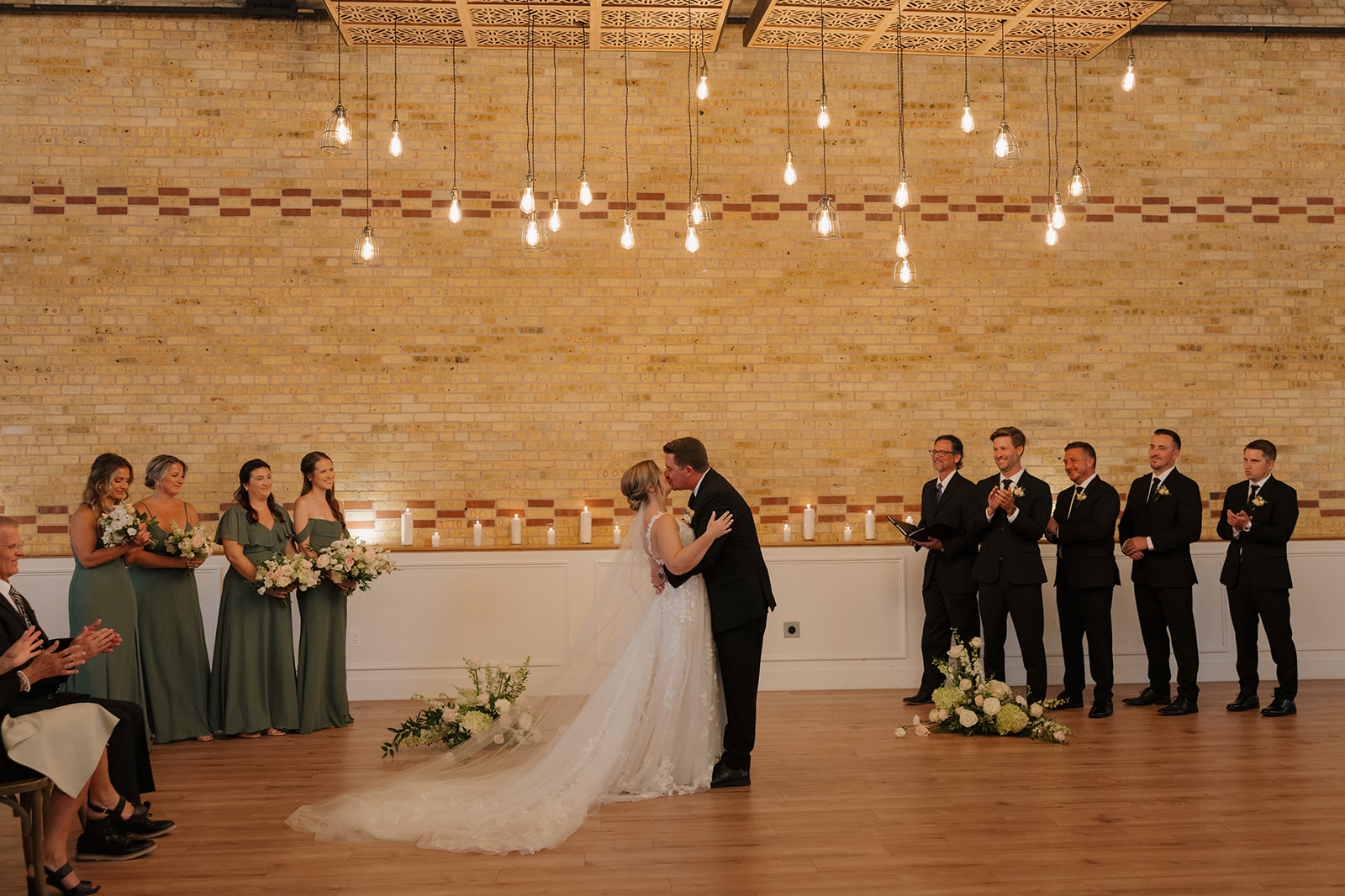 Happy couple kisses as newly married husband and wife during ceremony at 10 South wedding venue 