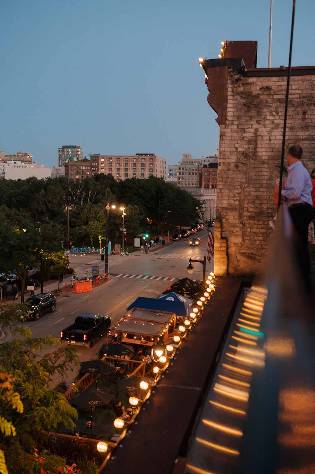 Downtown Milwaukee street scene at dusk from a rooftop venue during a summer wedding in Wisconsin.