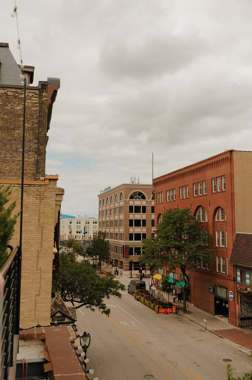 Busy downtown view of Wisconsin featuring historic brick buildings and a cloudy sky
