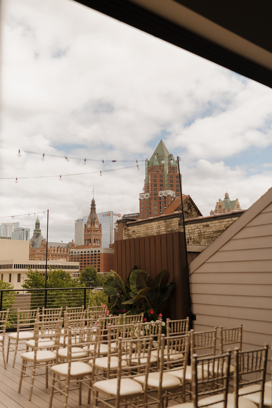 Rows of gold wedding chairs set up before intimate wedding in Wisconsin with incredible skyline view