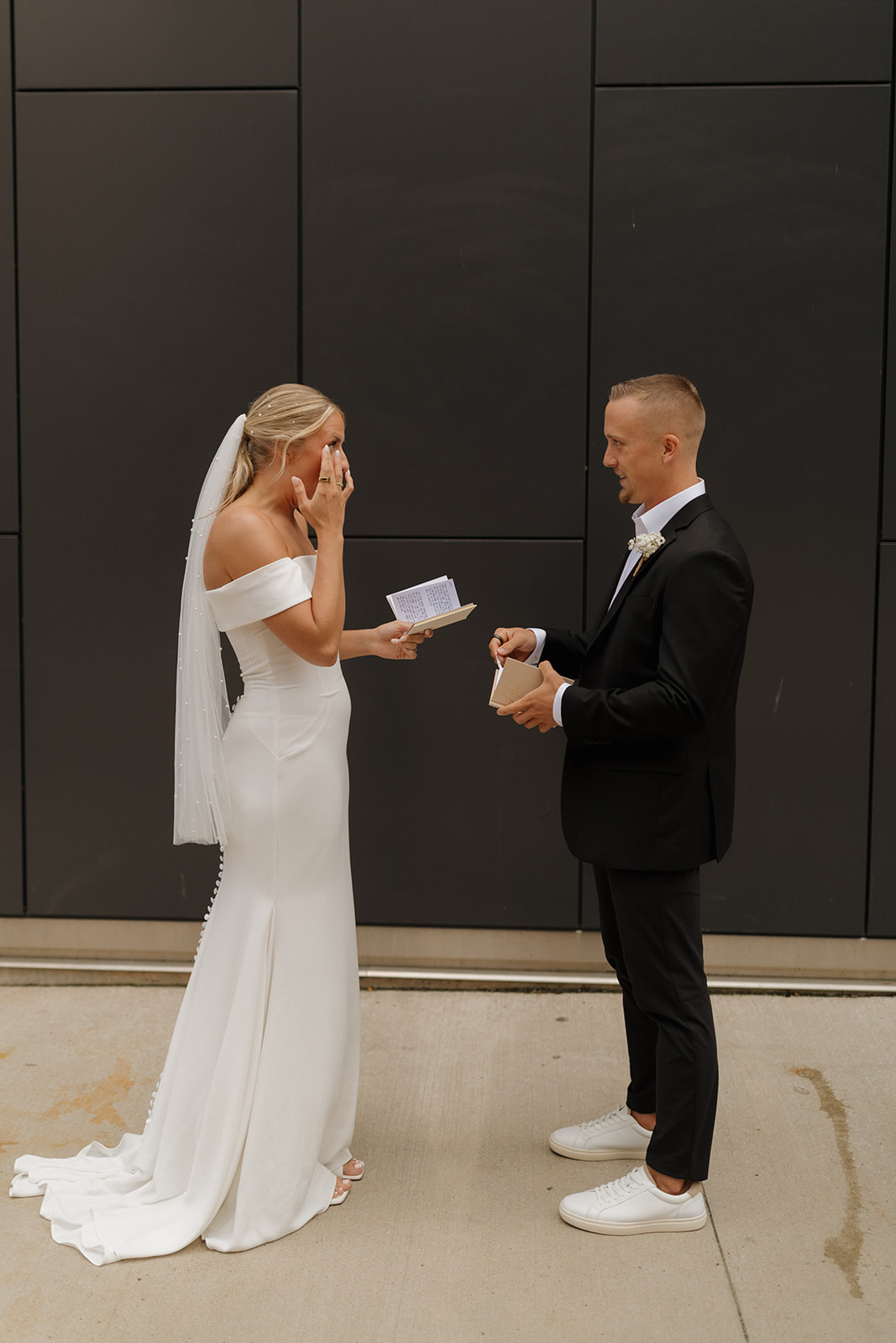 Bride gets emotional reading vows to her groom during private vow reading before wedding in Wisconsin