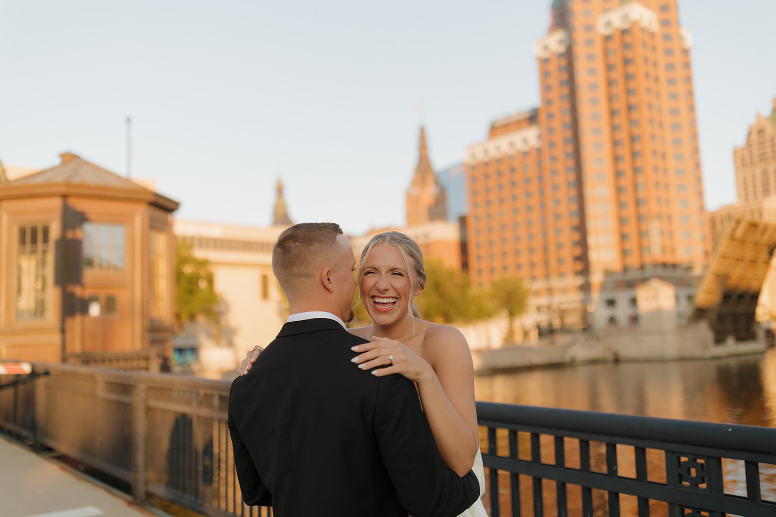 Bride laughing in her groom’s arms during a joyful wedding in Wisconsin.