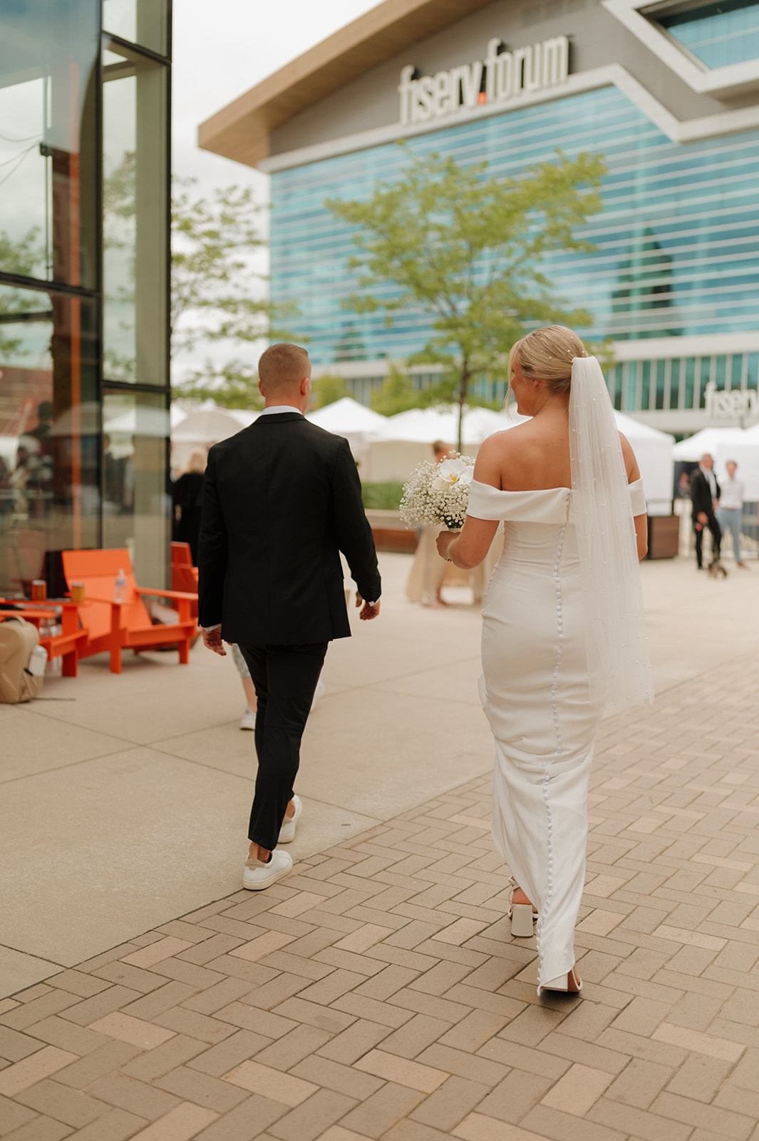 Bride and groom walk toward ceremony after private vow reading before wedding in Wisconsin.