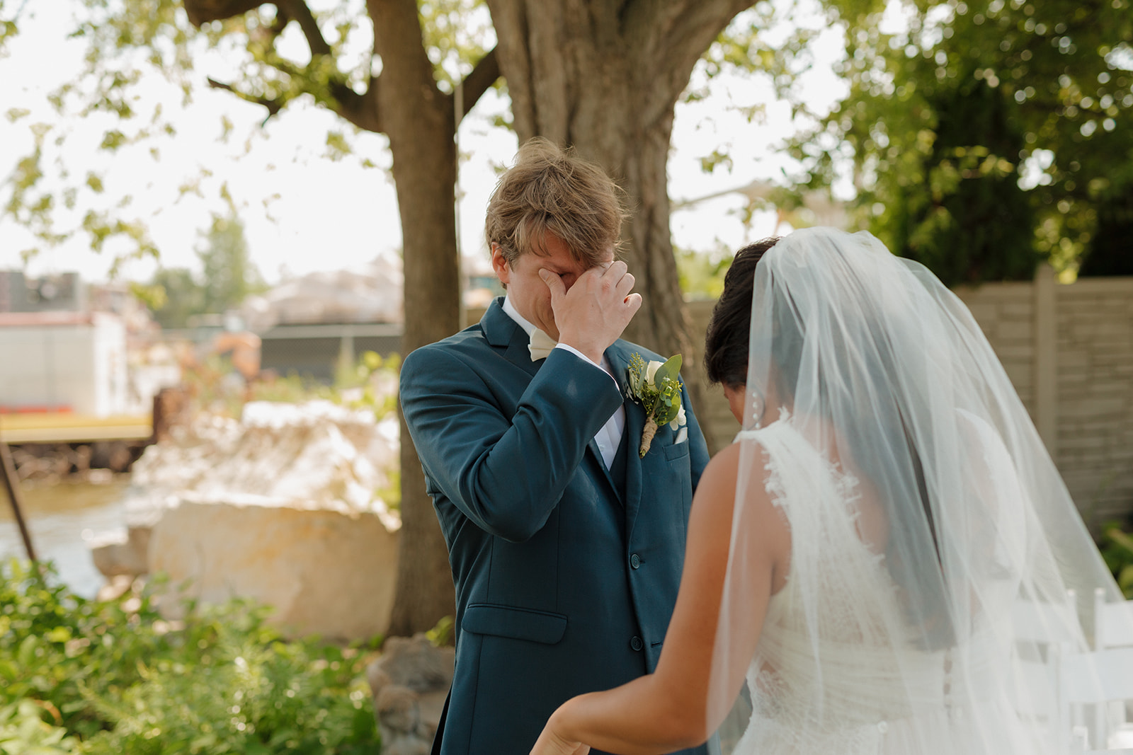 Groom gets emotional seeing his bride for the first time and begins wiping away tears