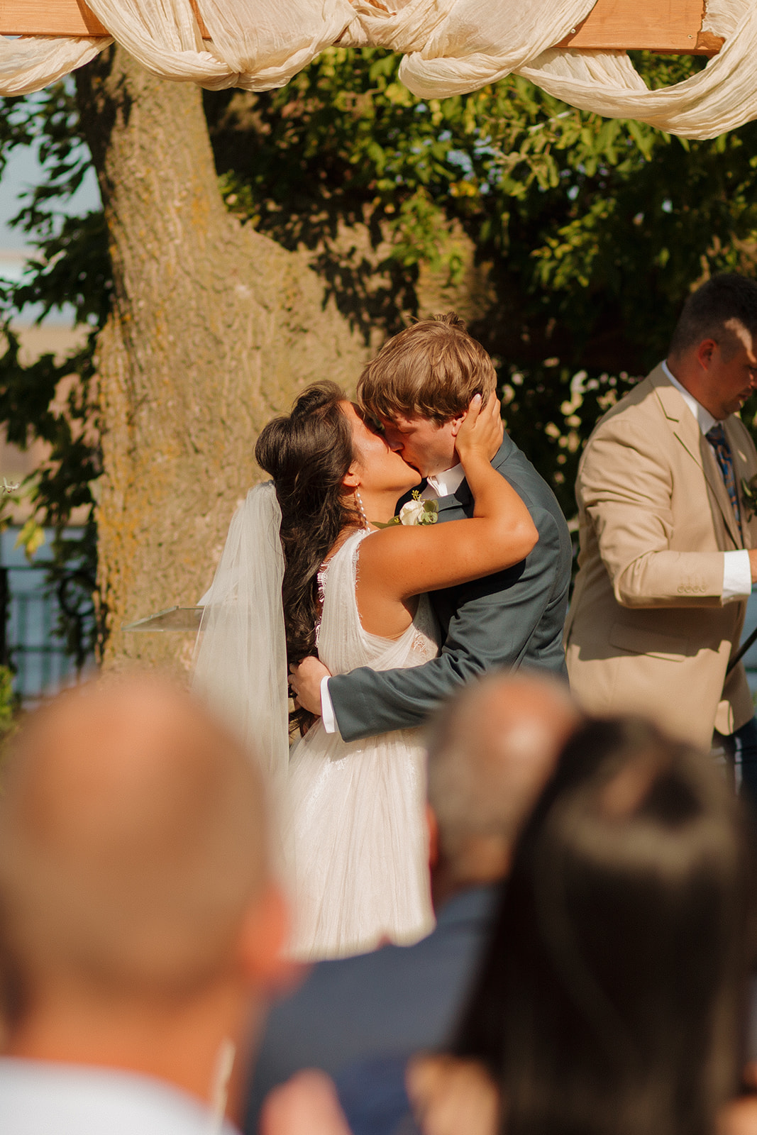 Bride and groom kiss as newly married couple at Milwaukee wedding venue